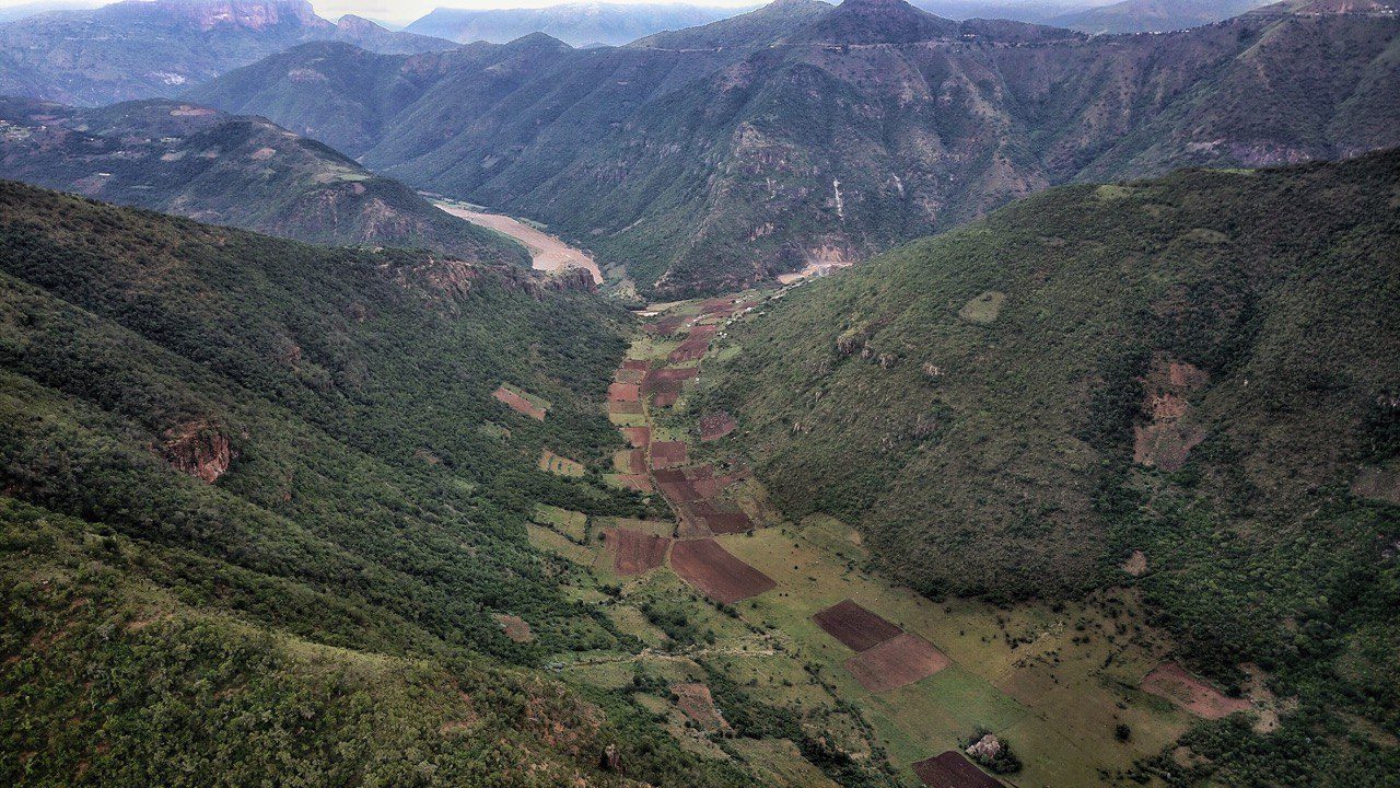Aerial view of a river valley in the Eastern Cape with small fields on the valley floor